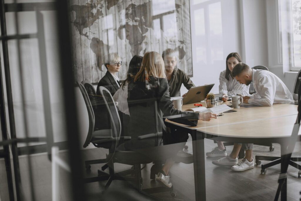 Professionals in a meeting room engaged in a collaborative business discussion.